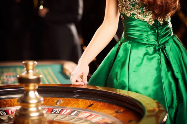 A young woman relaxing with her phone while dynamic casino elements float around her, illustrating the smooth mobile experience offered by the ZEUS75 app.