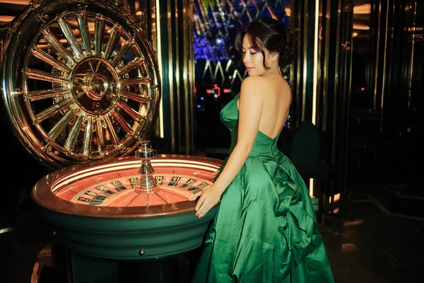 A close-up shot of golden coins falling around a spinning roulette wheel, representing immersive casino action at ZEUS75.